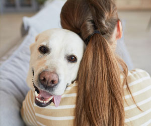 Woman hugging her dog